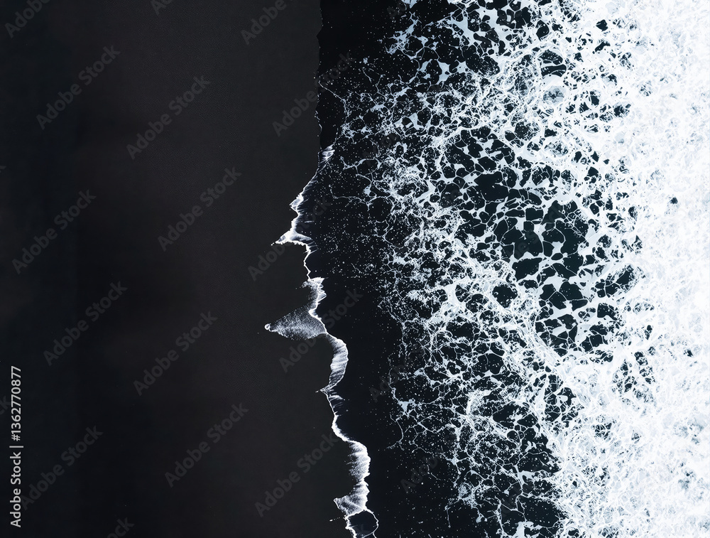 Poster aerial view of ocean waves crashing onto dark sand, creating a contrasting pattern. the bright white