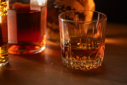 Glasses of whiskey on wooden table