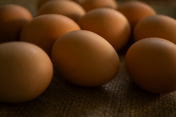 Studio shot of fresh brown eggs on burlap