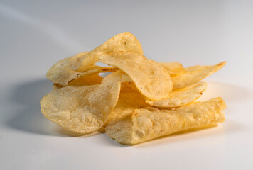 Studio shot of stack of potato chips on white background