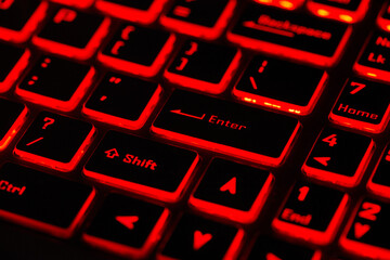 Close-up of red and black illuminated laptop keyboard