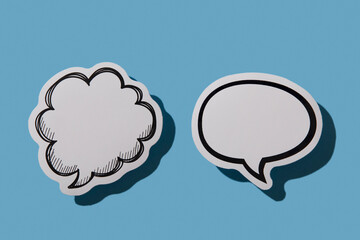 Two blank thought bubbles on blue background