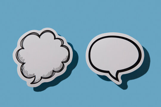 Two blank thought bubbles on blue background