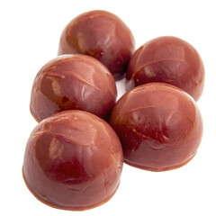 Fototapeta premium Five Delicious Red Chocolate Candy Balls Close Up Studio Shot