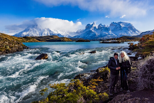 Portrait of couple at Falls at outlet of Lake Pehoe in Torres Del Paine