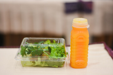 Orange juice in a bottle and snacks for a meeting on the table