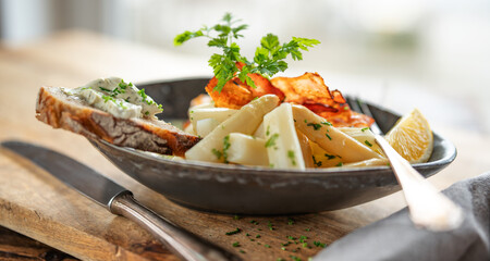 White asparagus with fresh ingredients in a dark ceramic bowl on rustic wood. Background for halthy...