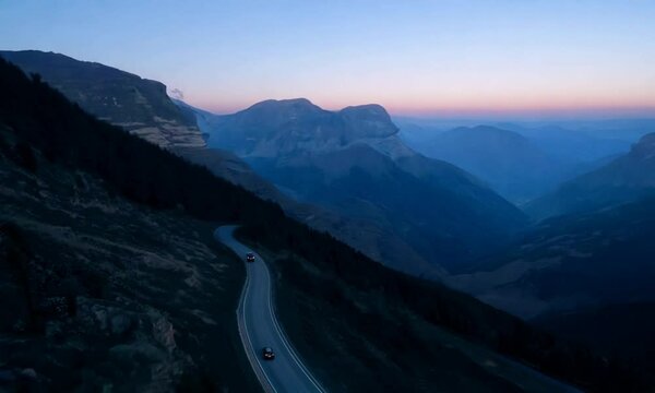 Winding road through a mountainous landscape at dusk