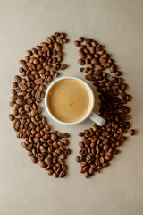 Coffee cup surrounded by roasted beans creates a warm cozy atmosphere