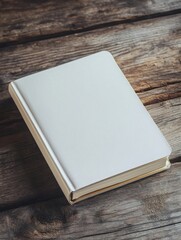 Fototapeta premium A5 notebook mockup, angled view of a notebook with a blank cover, placed on a rustic wooden table