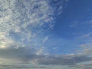 Fototapeta premium beautiful morning blue sky gradation sunrise sky background, beautiful cloudy sky sunlight from the side, dramatic feel, it's going to rain