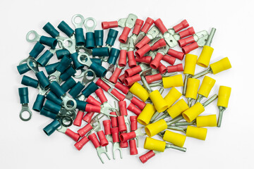 Variety of wire terminals in different colors arranged neatly on a white background