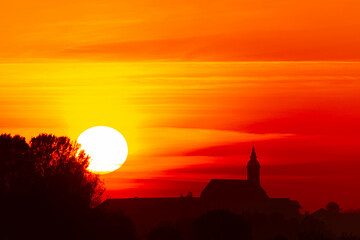 Megazoom (600mm) sunset with a church silhouette near Arbing, Osterhofen, Deggendorf, Bavaria,...
