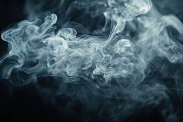 Smoke swirling on black background, creating mysterious patterns and shadows.