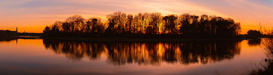 Naklejka premium High resolution stitched summer sunset panorama with reflections near Straubing, Danube, Straubing-Bogen, Bavaria, Germany