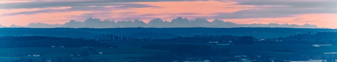High resolution stitched alpine sunset panorama of the 150 Km distant alps seen from Mount...