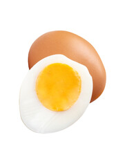 Front view of raw brown chicken egg and cooked or boiled chicken egg with egg yolk in half in small pile isolated with clipping path in png file format