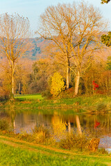 Autumn or indian summer view with reflections in a pond near Arbing, Osterhofen, Deggendorf, Bavaria, Germany