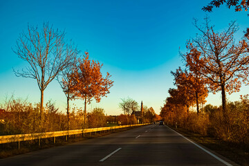 Fototapeta premium Autumn or indian summer sunset with a church near Straubing, Danube, Straubing-Bogen, Bavaria, Germany