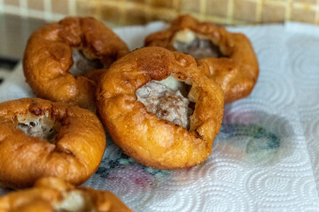 Delicious deep-fried belyashi tatar filled with meat resting on paper towel