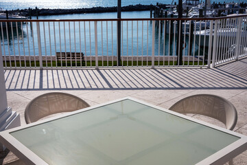 Fototapeta premium table and chairs on the terrace by the ocean