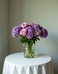Fototapeta premium A vase filled with purple and pink flowers on a white table
