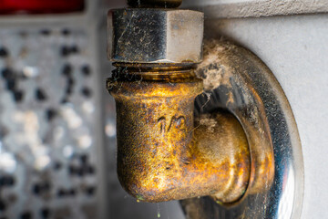 Close-up of a plumbing pipe adapter for cold water in corrosion.