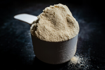 Full scoop with a slide of sports nutrition close-up