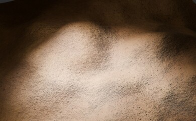 Fototapeta premium Abstract textured surface, spotlight on a desert-like backdrop