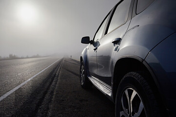 A car for traveling on a road with fog and sun