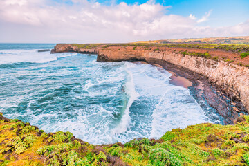 Coastal cliffs along California's Highway 1 in California. Rugged ocean rocks, crashing waves, and...
