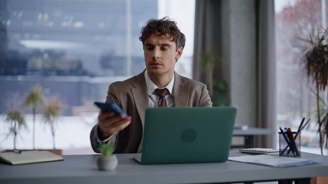 Serious coworker looking cellphone receiving money lost notification closeup