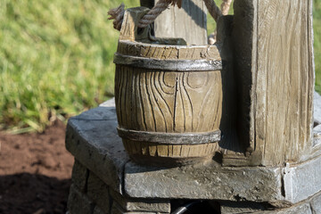 Naklejka premium A tiny well with water coming from a bucket