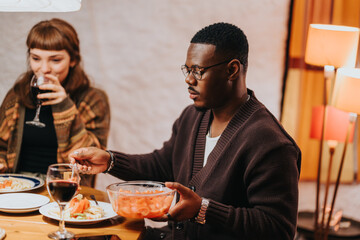 Two friends share a pleasant dinner together, enjoying conversation and a cozy ambiance.