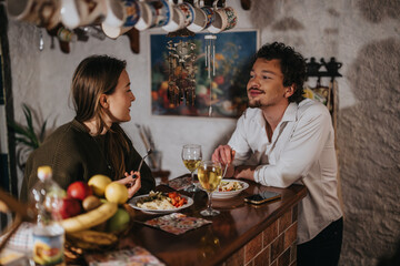 Casual gathering of two friends sharing a meal while conversing in a cozy atmosphere. Warm tones and a rustic interior enhance the comfort of their friendly and relaxed interaction.