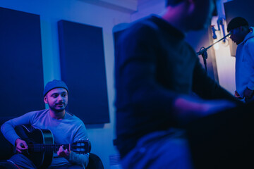 Musicians working together in a recording studio, creating music. The image captures the collaborative atmosphere and the harmony among the artists as they engage in their creative process.