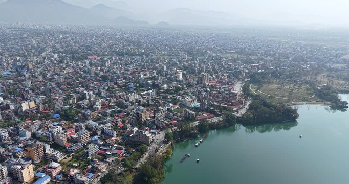 aerial shot overlooking the city of Pokhara, Nepal, situated beside the distinctive Phewa Lake