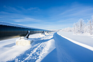 Obraz premium Snow-covered pipeline stretches across a winter landscape Generative AI