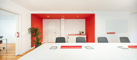 Modern office meeting room with bold red accents
