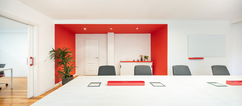 Modern office meeting room with bold red accents