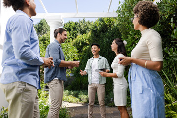 At garden small casual wedding, friends joyfully conversing and sharing laughter and happiness