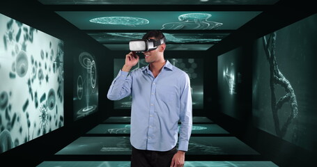 Image of businessman wearing vr headset over screens with medical data processing