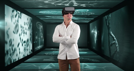 Image of businessman wearing vr headset over screens with medical data processing