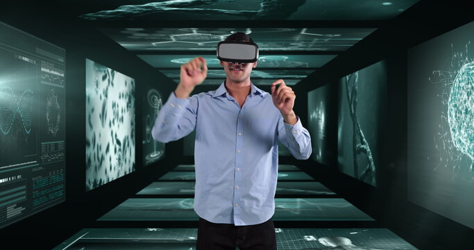 Image of businessman wearing vr headset over screens with medical data processing