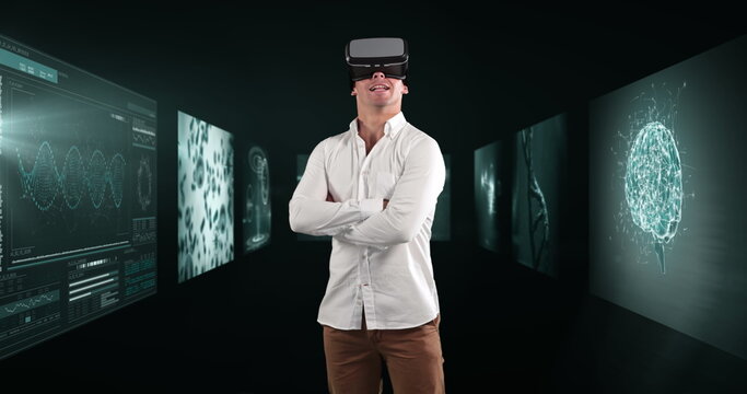 Image of businessman wearing vr headset over screens with medical data processing