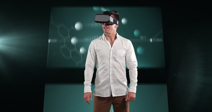 Image of businessman wearing vr headset over screens with medical data processing