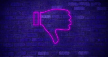 Neon pink thumbs down sign glowing against dark brick wall background