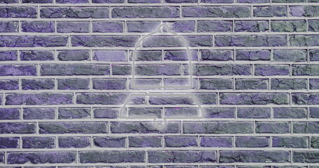 Neon bell icon glowing on textured brick wall, creating urban art vibe