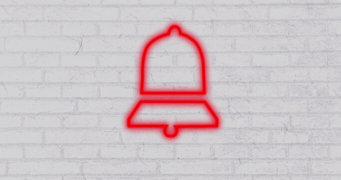 Red neon bell icon glowing against white brick wall, symbolizing notifications