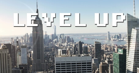 Image of white pixel text level up, over modern cityscape